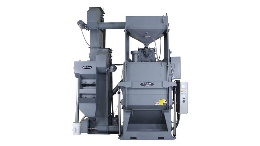 Image is of a Gibson tumble wheel blast system. It is a grey piece of machinery on a white background.