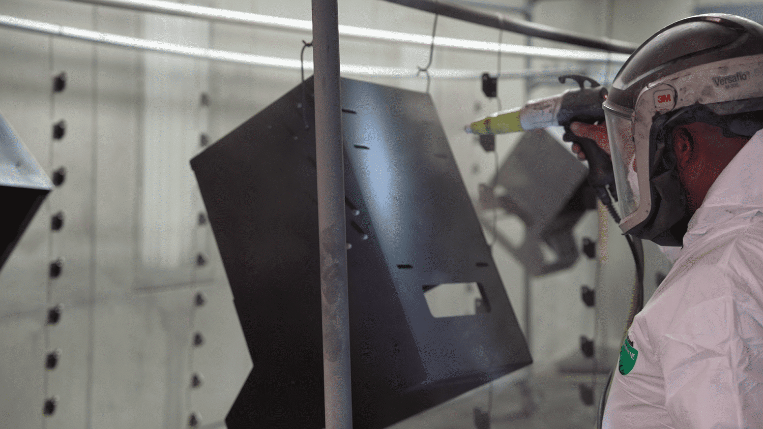 specialist finishing a part in full ppe